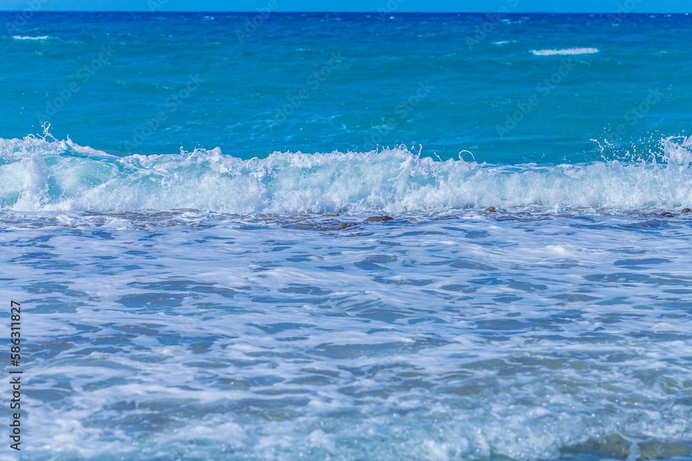 Sea waves with foam off the coast of a tropical island Sea waves with foam off the coast of a tropical island