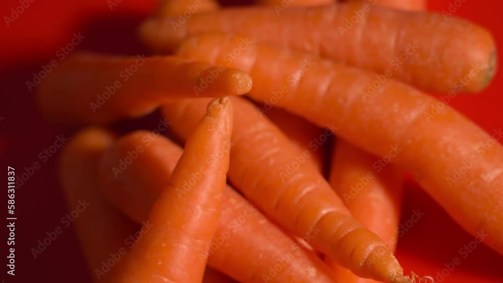 A bunch of carrots on the red table A bunch of carrots on the red table