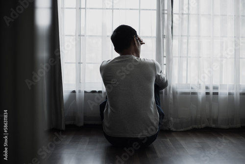 Sad young asian man in the bedroom, People and depression concept.	