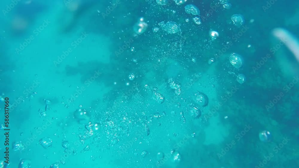 Many large bubbles in the azure sea water after scuba diving Many large bubbles in the azure sea water after scuba diving