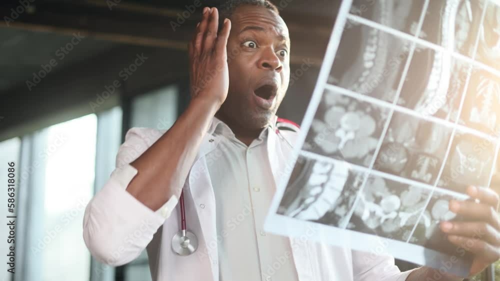 Portrait of shocked surprised scared african american man doctor