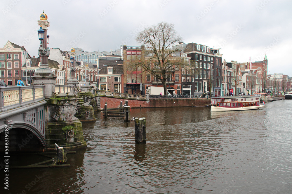 bridge (blauwbrug) and canal (amstel) in amsterdam (netherlands)
