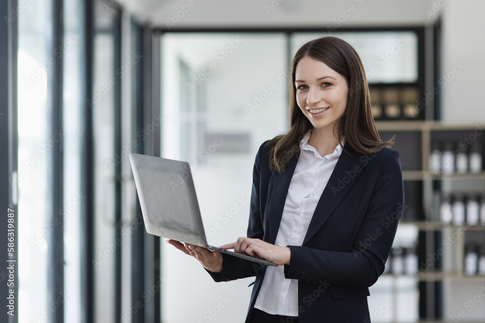 Happy excited young successful business woman and working online at the table in office, Happy excited young successful business woman and working online at the table in office,