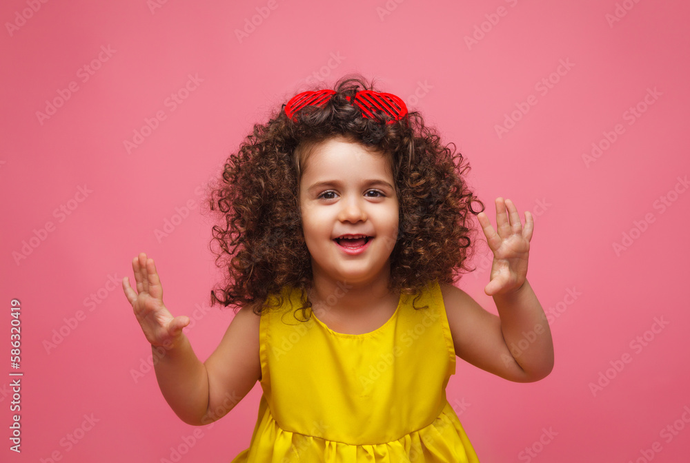portrait of a girl in a yellow dress cute attractive cute cheerful cheerful little girl .isolated pink background. portrait of a girl in a yellow dress cute attractive cute cheerful cheerful little girl .isolated pink background.
