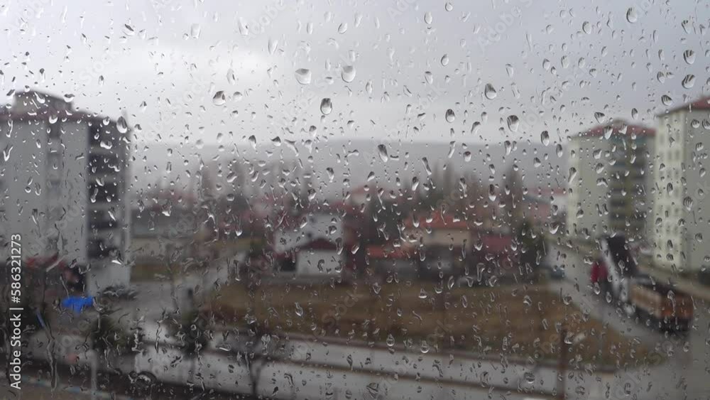 Water droplets formed on the balcony windows on a rainy day, while the rain droplets slide over the glass, Water droplets formed on the balcony windows on a rainy day, while the rain droplets slide over the glass,