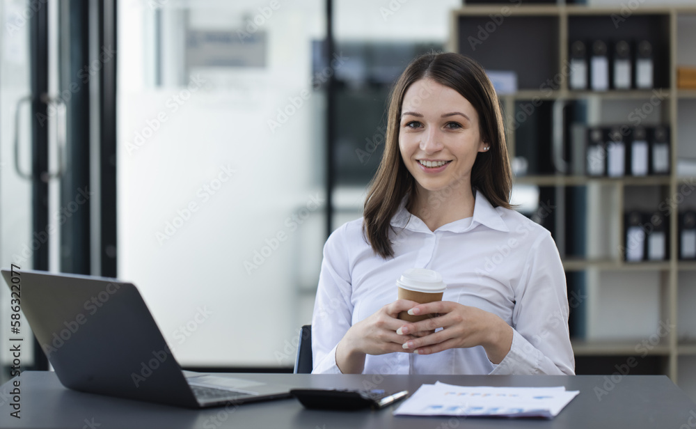 Happy excited young successful business woman and working online at the table in office, Happy excited young successful business woman and working online at the table in office,