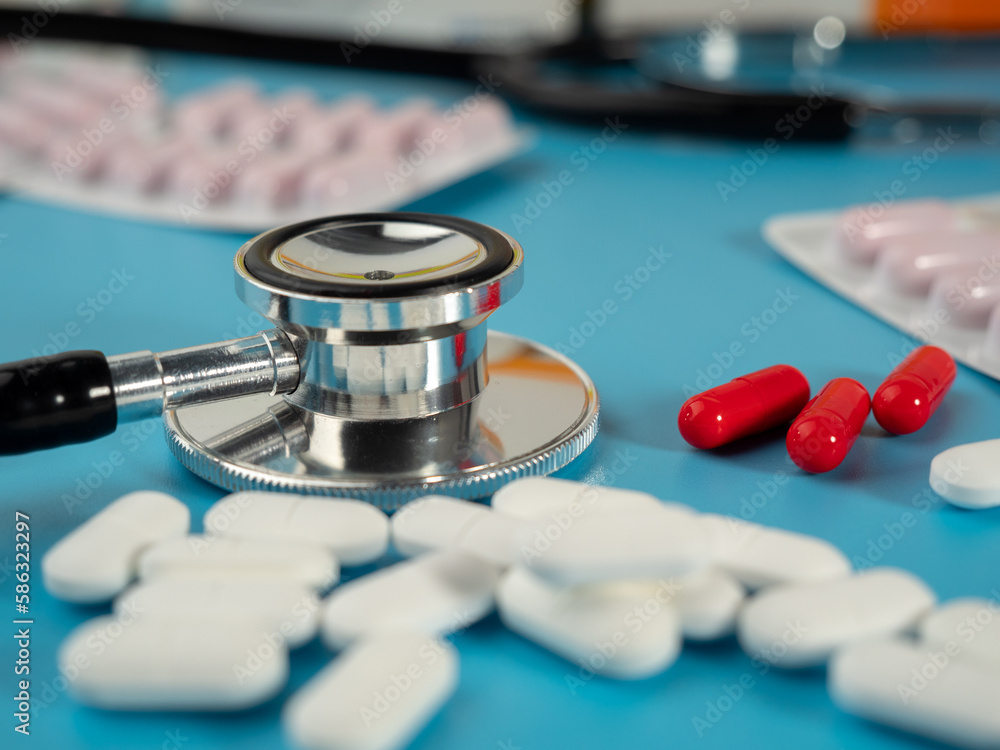 Medicines and a stethoscope. Capsules and tablets. Close-up. Medicines and a stethoscope. Capsules and tablets. Close-up.
