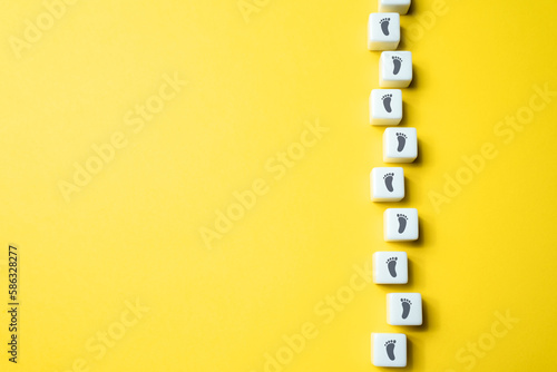 Direction from footprints on blocks. Progress and success are achieved by taking one small step at a time. Trust in their ability to navigate it successfully. Each step brings closer to destination