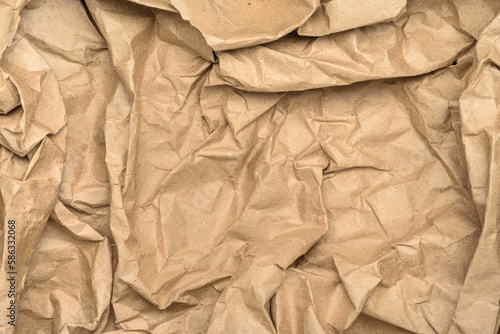 Crumpled brown paper texture or background. Packaging material with rough wrinkles.