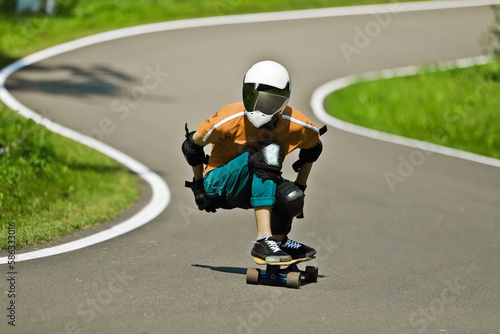 stylish man in a helmet rides a longboard and does a trick