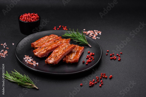 Grilled fresh juicy ribs with salt, spices and herbs