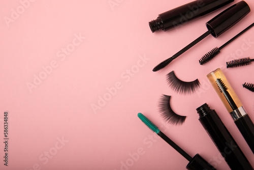 Composition with false eyelashes, mascara and eyelash brushes, eyelash curlers on a pink background. Makeup artist tools. Beauty concept. Makeup. Place for text. Place for copying. Flatley. MOCAP.