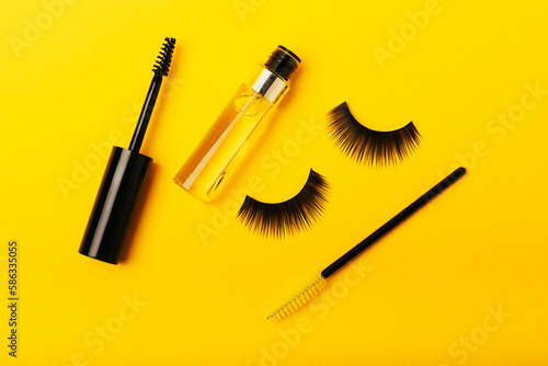 Fototapeta Naklejka Na Ścianę i Meble -  Gel for the growth of eyelashes and eyebrows. Serums, essential oils or essences for eyelash growth with a strong effect on a yellow background. Place for text. Place to copy. MOCKUP