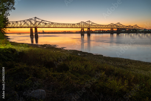Sunset on the Mississippi River in Natchez, Mississippi with the Natchez Vidalia Bridge. photo