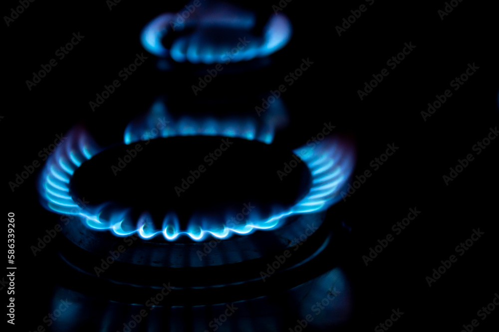 Burners with blue flames on black background