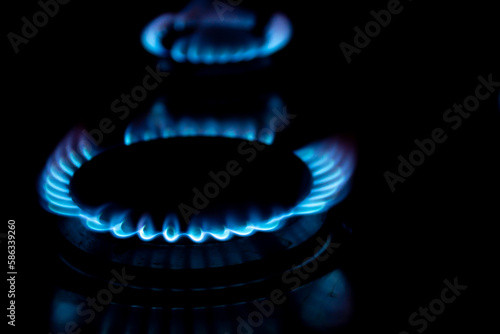 Burners with blue flames on black background