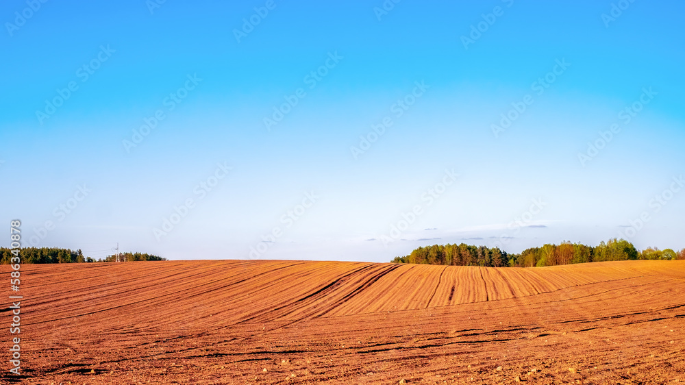 Plowed agricultural field in the rays of the evening sun. Rich, warm colors Plowed agricultural field in the rays of the evening sun. Rich, warm colors