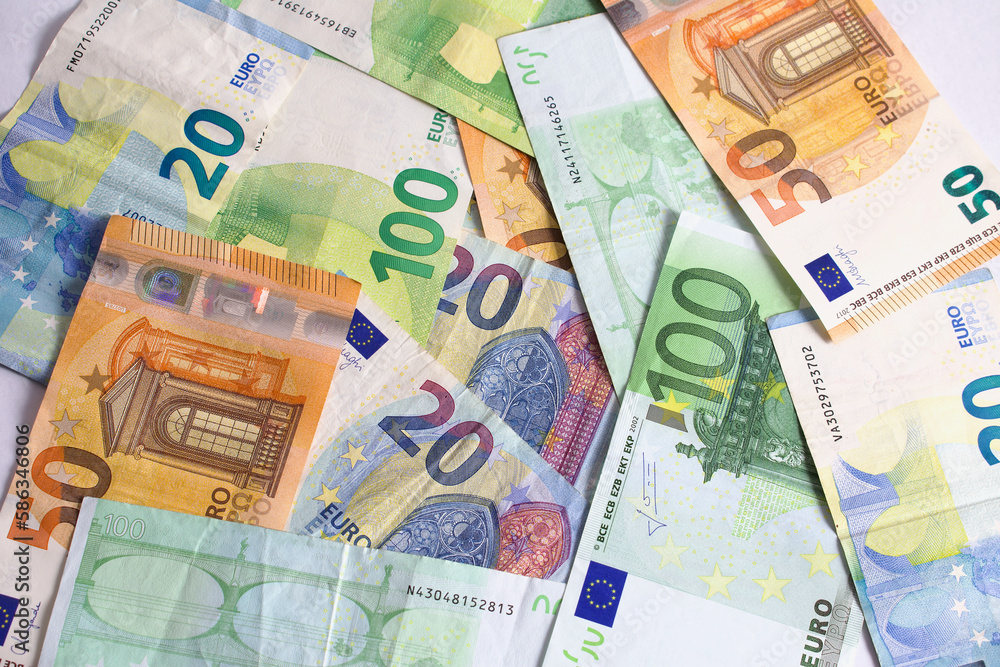Obraz premium Pile of cash euro banknotes on the table in value of twenty euros, fifty euros, five euros, one hundred. Background with money.