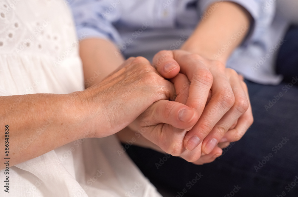 An adult woman holding an elderly mother-grandmother by the hands. An adult woman holding an elderly mother-grandmother by the hands.