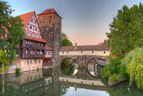 Sunset view of Weinstadel building, water tower, Henkerbrücke bridge and Henkerturm tower in Nürnberg, Germany. photo