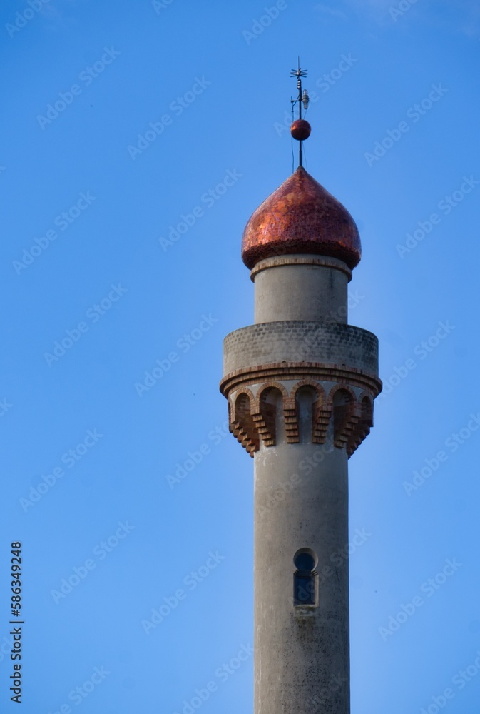Minaret against blue sky. Islamic culture.