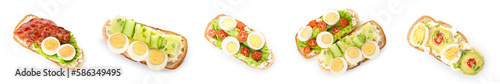 Set of tasty toasts with boiled eggs on white background, top view