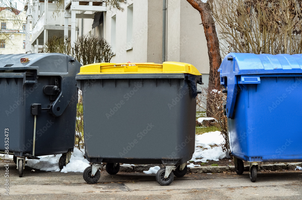 View of garbage containers in city on winter day View of garbage containers in city on winter day
