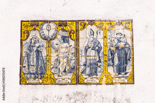 Traditional hand painted azulejos tiles depicting Madonna and Child, and saints Sebastian, Marsal, and Antonio.