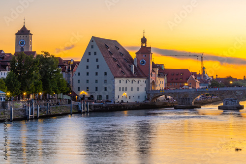 Sunset view of the Old stone bridge over river Danube in Regensburg, Germany photo