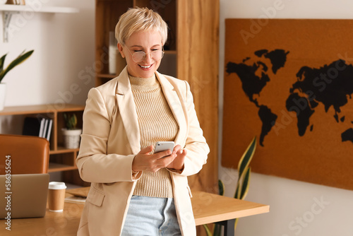Mature businesswoman using ...