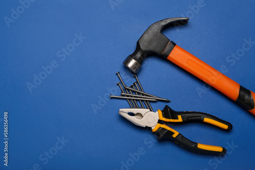 Pliers, hammer and nails on...