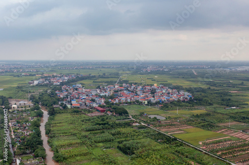 Aerial view of residential neighborhood roofs. Urban housing development from above. Top view. Real estate in Hanoi City, Vietnam. Property real estate. © tampatra