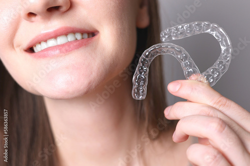 Aligners for straightening teeth in a woman's hand