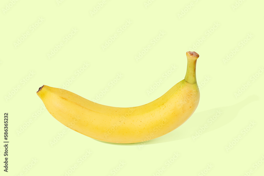 Fresh yellow banana on green pastel background
