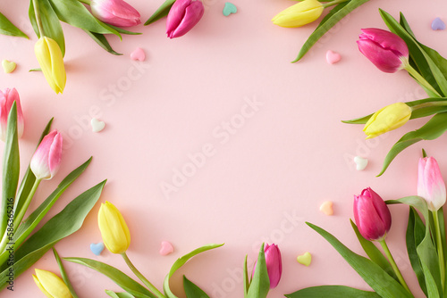 Wallpaper Mural Top view composition of yellow pink tulips flowers and colorful hearts baubles on isolated pastel pink background with blank space in the middle. Happy Mother's Day idea Torontodigital.ca