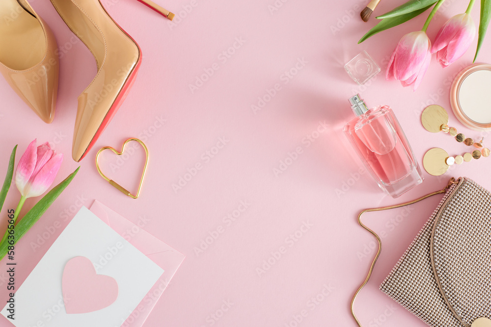 Top view photo of perfume bottle cosmetics bijouterie earrings trendy women shoes handbag postcard with heart and tulips on pastel pink background with empty space. Women's Day atmosphere concept