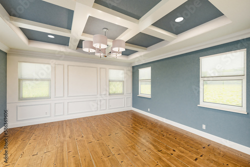 Beautiful Blue-Gray Custom Master Bedroom Complete with Entire Wainscoting Wall  Fresh Paint  Crown and Base Molding  Hard Wood Floors and Coffered Ceiling