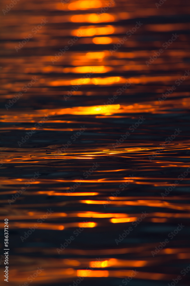 Surface of lake water with sunset colors