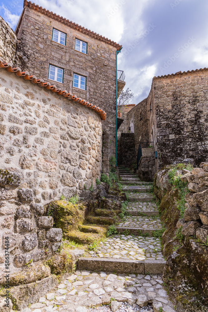 Cobbled stairway amid stone houses.