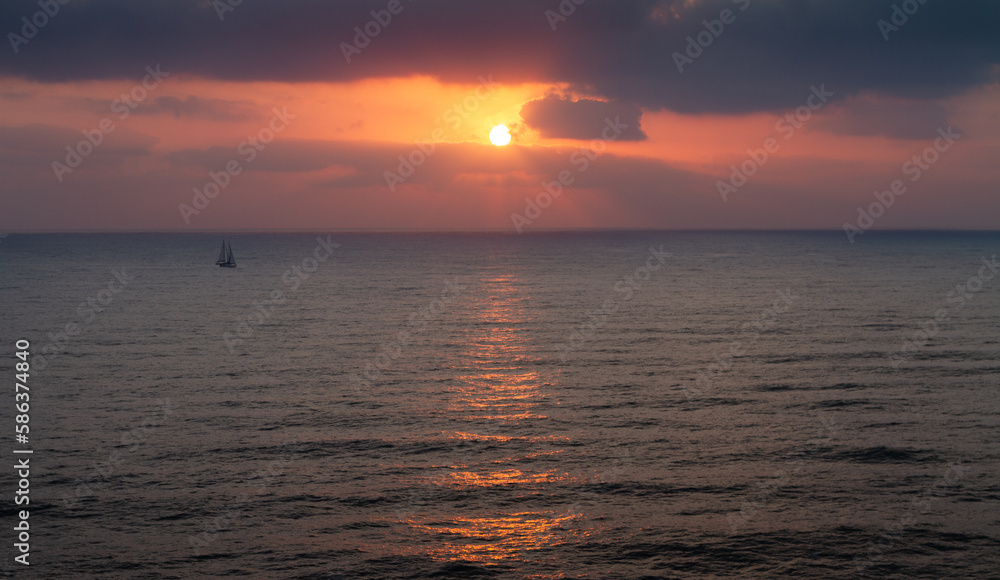 Sailboat goes on the waves during sunset. Seascape panorama Sailboat goes on the waves during sunset. Seascape panorama