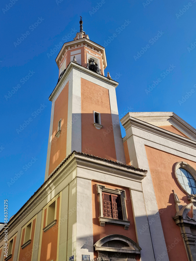 A fragment of the tower of one of the churches in the center of Madrid on a sunny and cloudless day, Madrid, Spain.