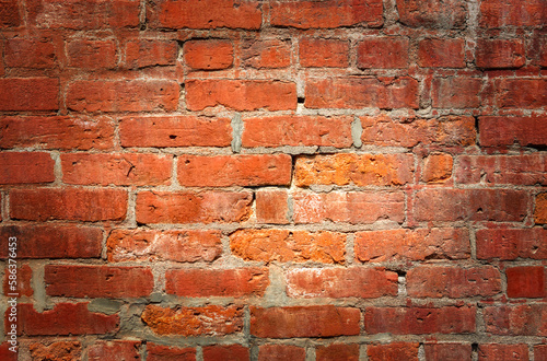 red brick wall with spotlight lit center