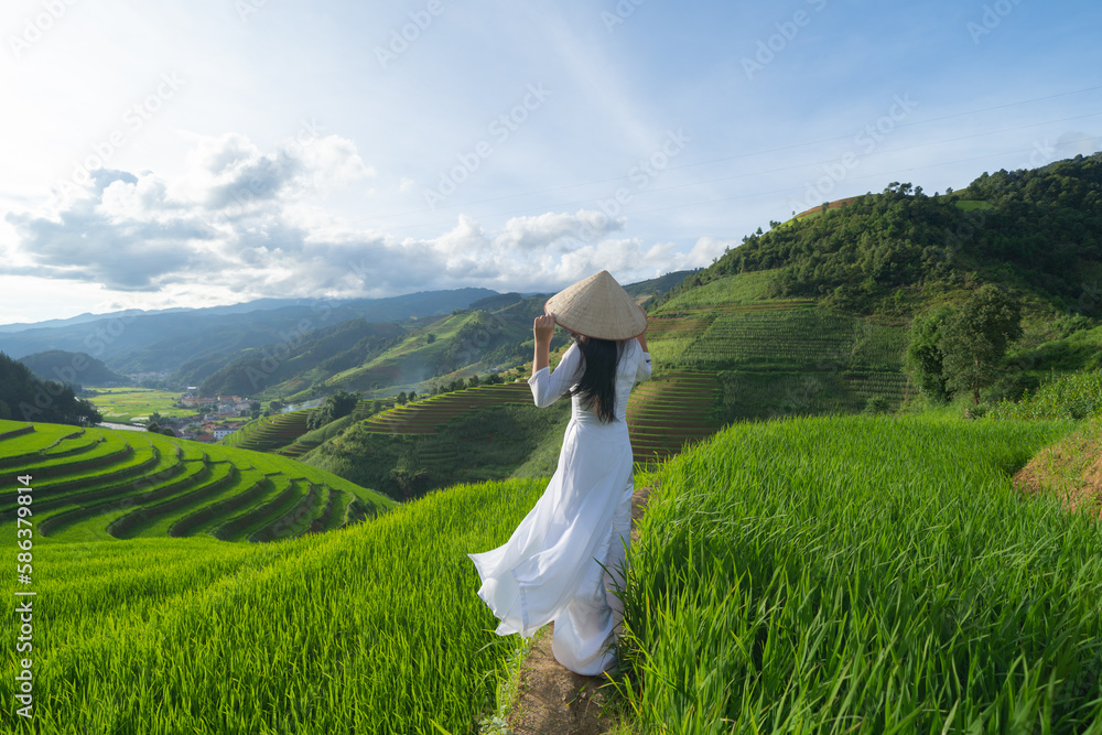 A farmer with fresh paddy rice terraces, green agricultural fields in countryside or rural area of Mu Cang Chai, mountain hills valley in Asia, Vietnam. Nature landscape. People lifestyle. A farmer with fresh paddy rice terraces, green agricultural fields in countryside or rural area of Mu Cang Chai, mountain hills valley in Asia, Vietnam. Nature landscape. People lifestyle.