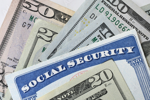 Social Security Card with cash money dollar bills - living on a fixed income, benefits SSN photo