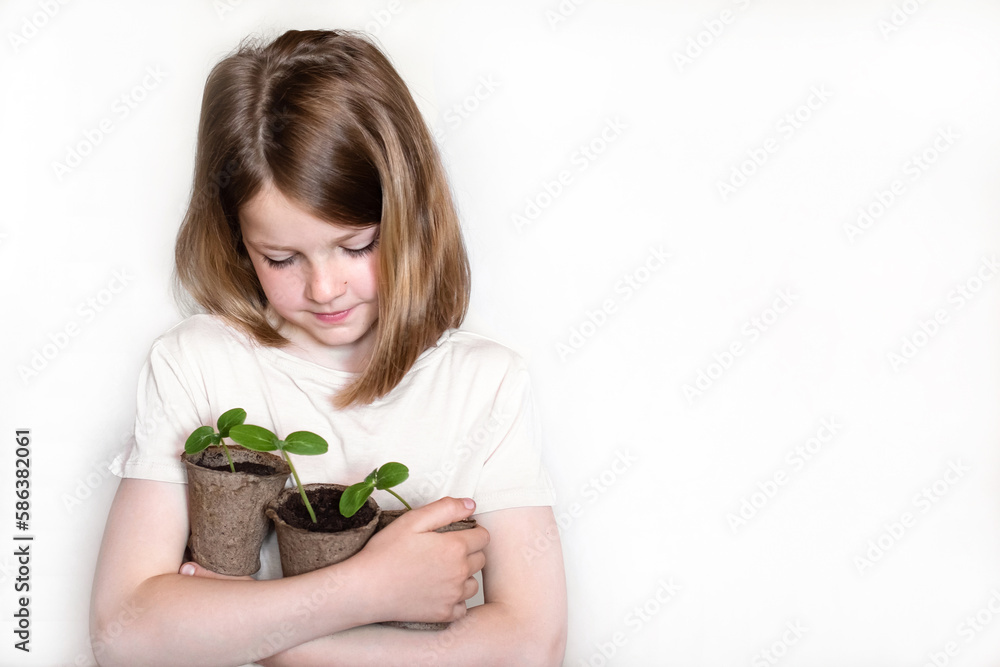 Healthy seedlings, hobby gardening. cute girl examines and plays with plants at home on the windowsill. concept of learning and care. girl with organic plants on white background Healthy seedlings, hobby gardening. cute girl examines and plays with plants at home on the windowsill. concept of learning and care. girl with organic plants on white background