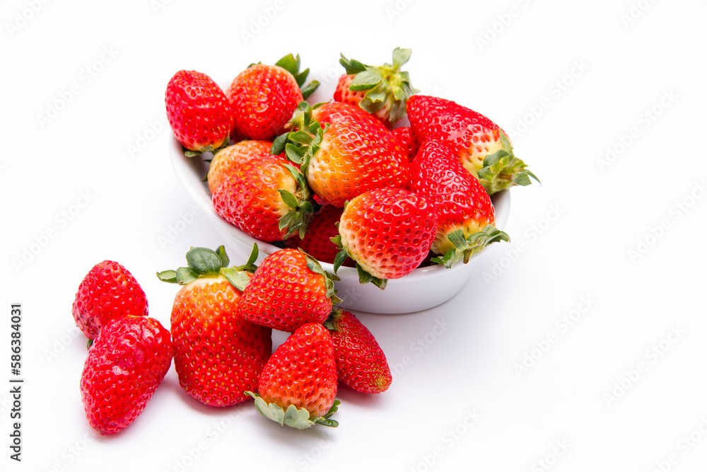 Fresh organic Strawberries piled high in a ceramic dish Fresh organic Strawberries piled high in a ceramic dish