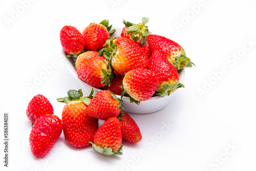Fresh organic Strawberries piled high in a ceramic dish
