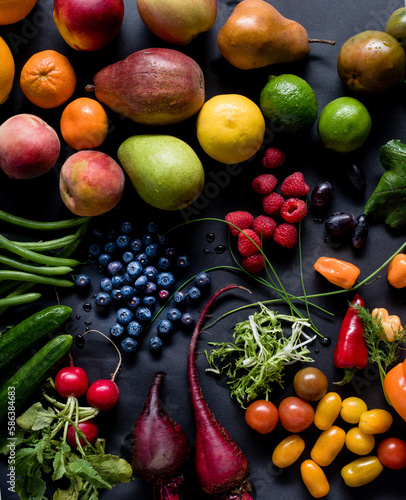 An Assortment of fruits and vegetabels on a black background photo