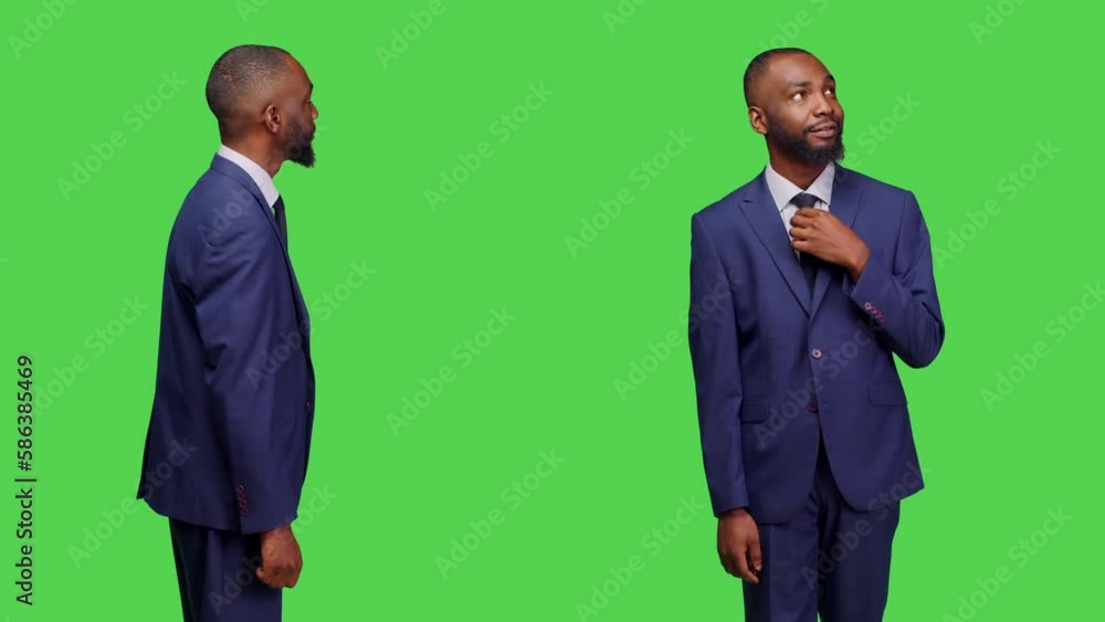 Optimistic adult standing over green screen backdrop on camera, posing with confidence and feeling happy in business suit. Young man working as company manager, confident employee. Optimistic adult standing over green screen backdrop on camera, posing with confidence and feeling happy in business suit. Young man working as company manager, confident employee.