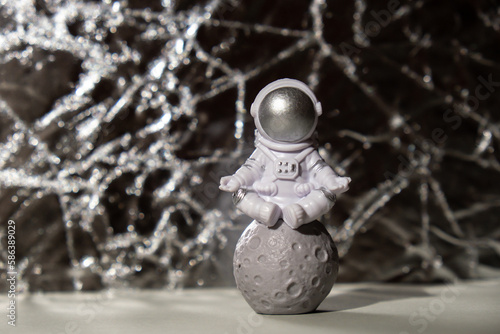 Plastic toy figure astronaut on silver background Copy space. Concept of out of earth travel, private spaceman commercial flights. Space missions and Sustainability © anna.stasiia